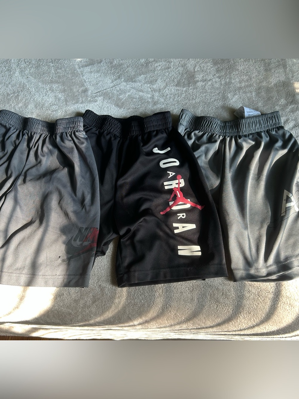 Jordan boy’s Black Athletic Shorts with Red Jumpman and White Lettering